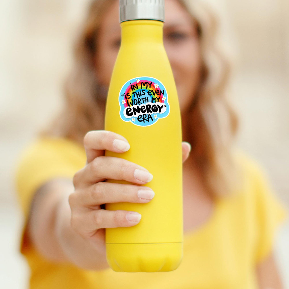 Hand holding a yellow water bottle with the Energy Era rainbow sticker, waterproof vinyl decal, funny boundaries quote gift for tumbler decor