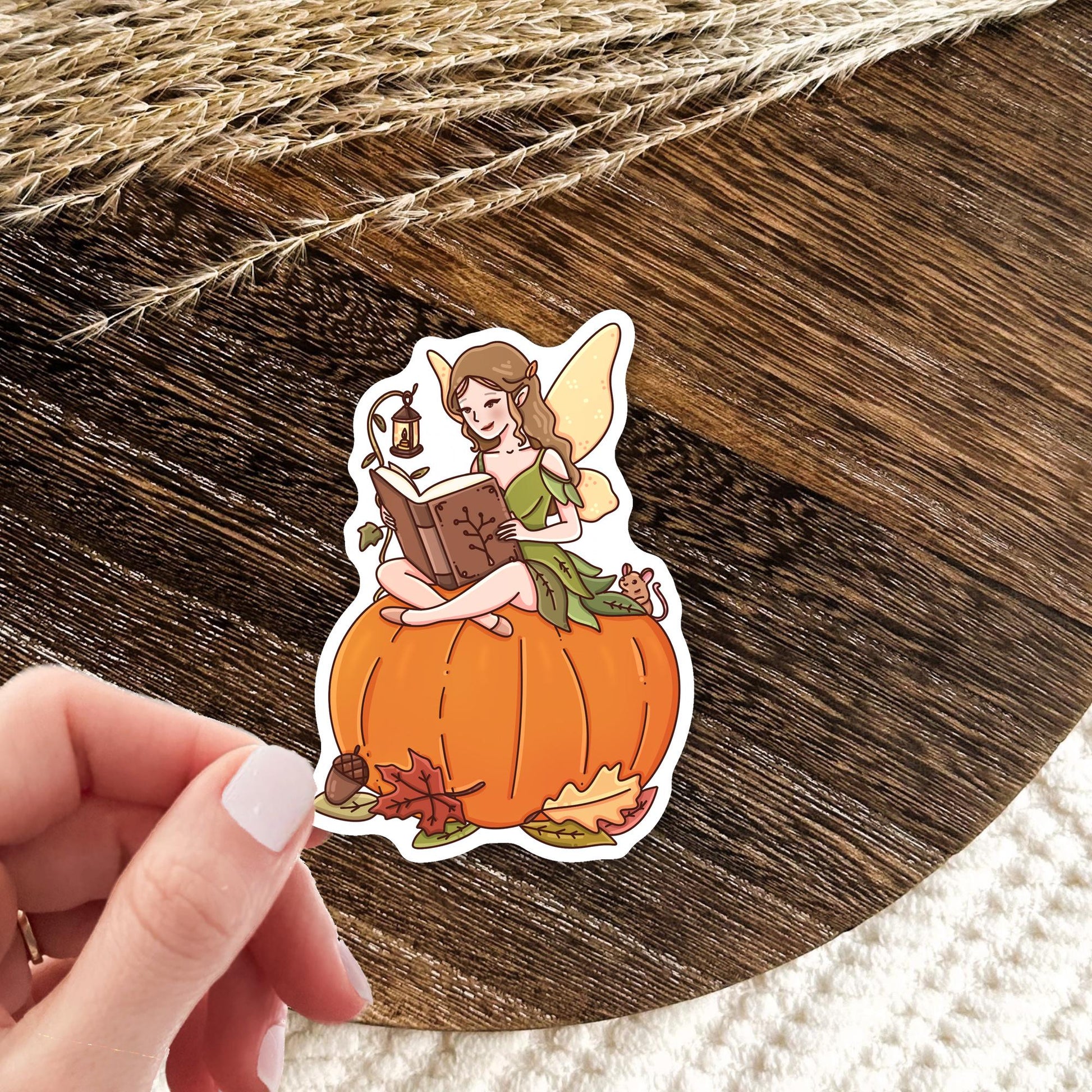 Autumn Fairy Tale die-cut sticker featuring a cozy bookish fall scene with enchanted forest magic