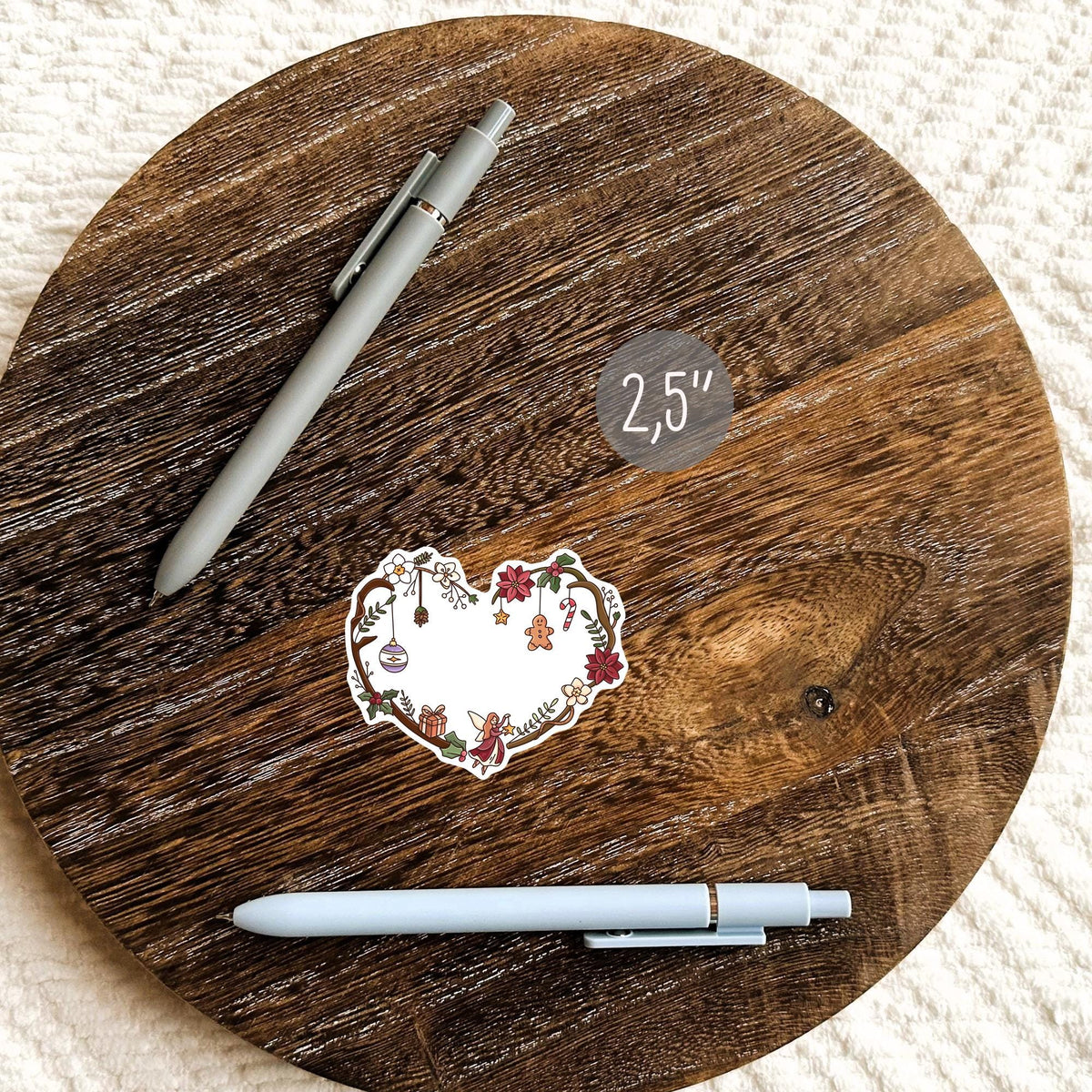 Cute Christmas heart sticker on a round wooden surface, waterproof vinyl holiday decal for planners, journals and cozy winter decor