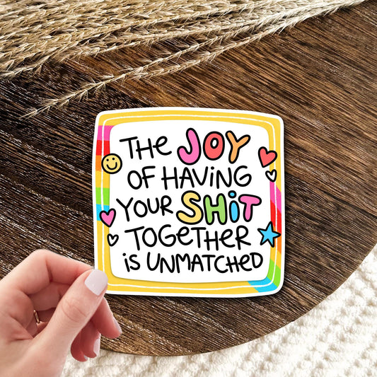 Joy Of Having Your Life Together rainbow frame vinyl die-cut sticker held in hand on wood, funny adulting humor gift