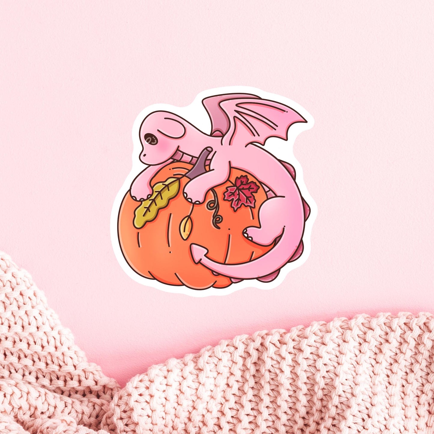 Pink Dragon autumn sticker on a laptop, cute fantasy die-cut sticker for book lovers who enjoy cozy reading season
