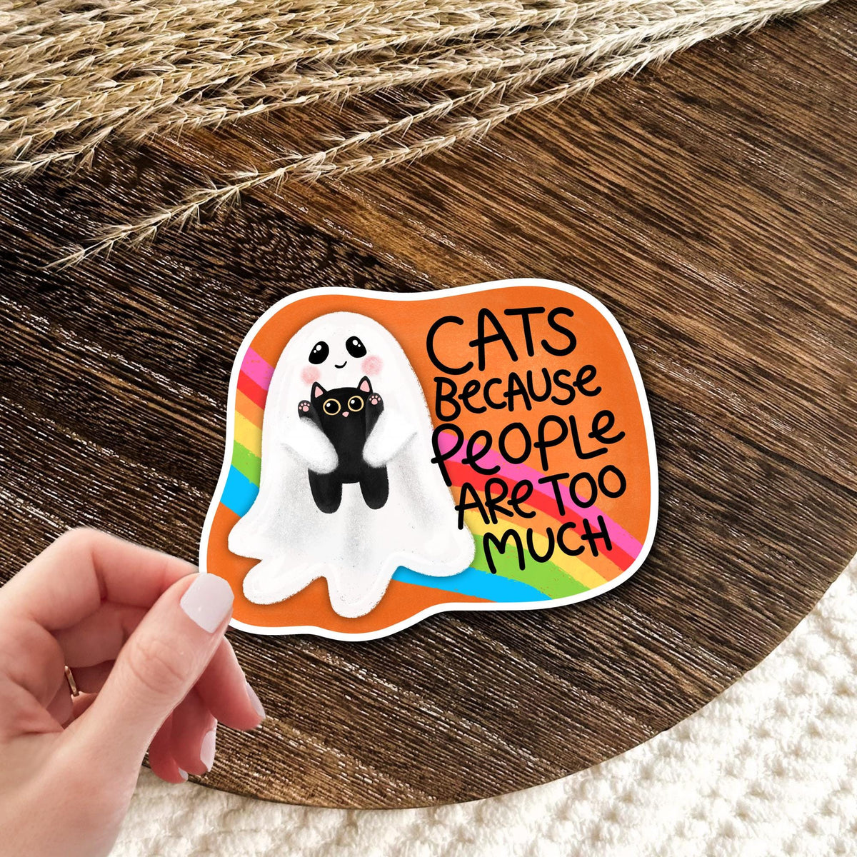 Cats Because People Are Too Much ghost cat vinyl die-cut sticker held in hand on wood, funny introvert humor gift for cat lovers
