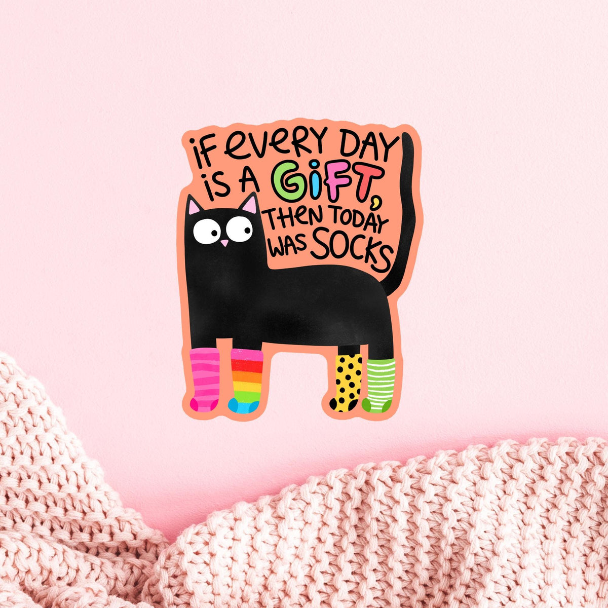 Black cat socks sticker on a pink planner