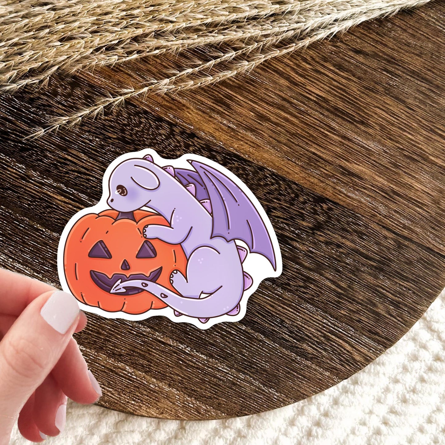 Purple Halloween Dragon sticker on a laptop, cute spooky die-cut sticker for book lovers who enjoy Halloween season