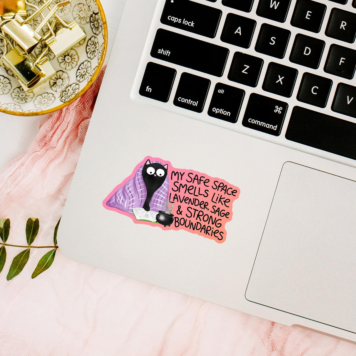 Black cat lavender blanket sticker on a laptop keyboard with gold decor