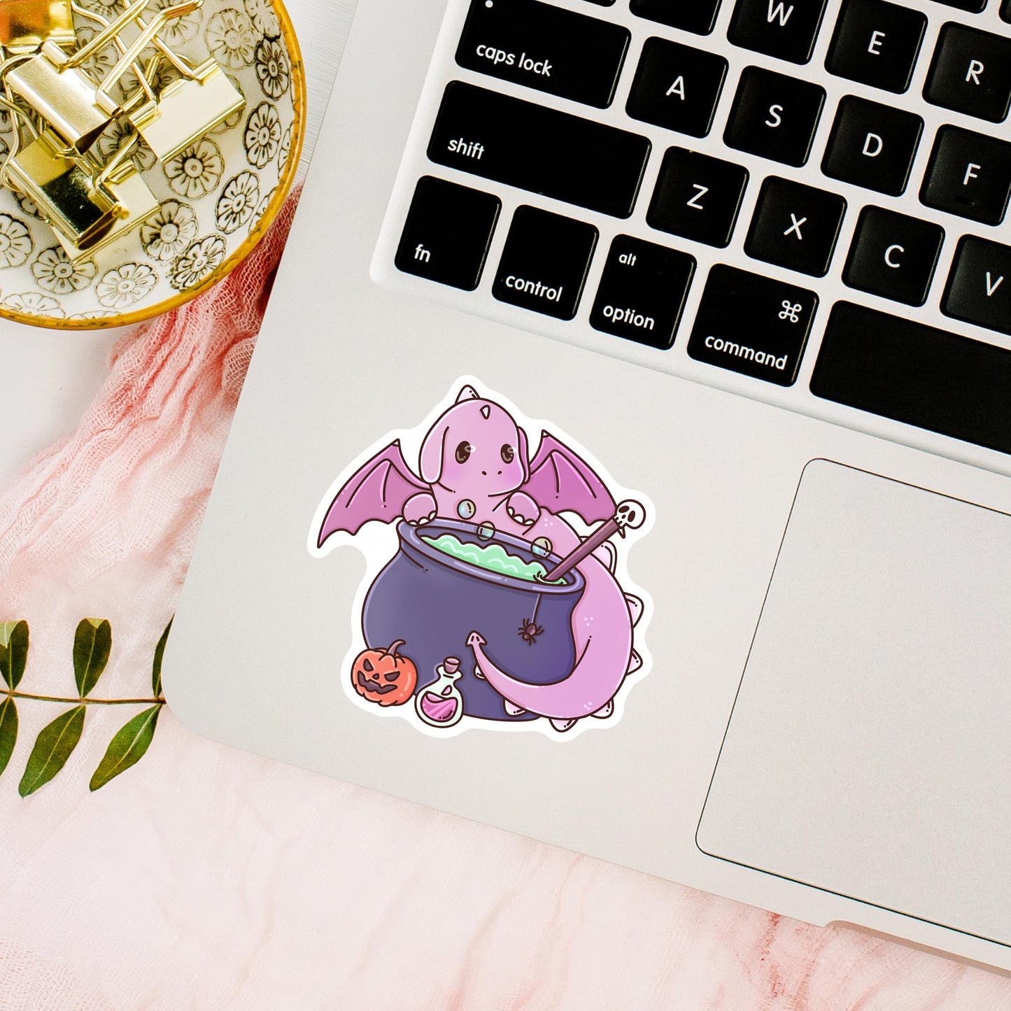 Pink Halloween Dragon die-cut sticker lifestyle photo, waterproof vinyl sticker for witchy pastel aesthetic book lovers