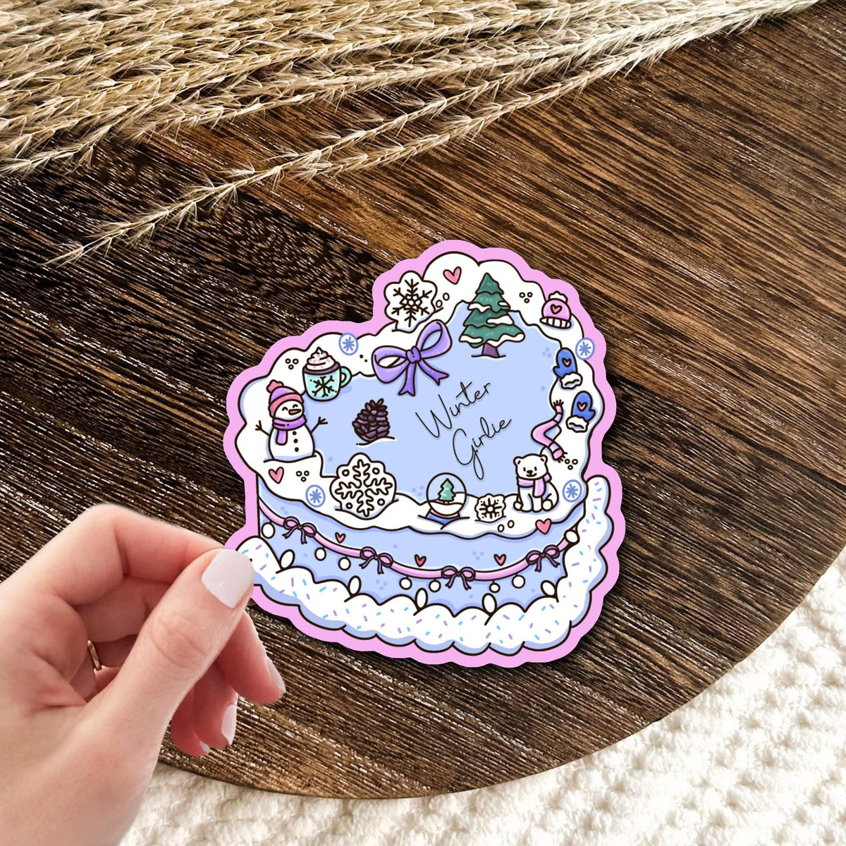 Winter Girlie Cake pastel vinyl die-cut sticker held in a hand, cute winter dessert decal, waterproof kawaii gift for baking lovers
