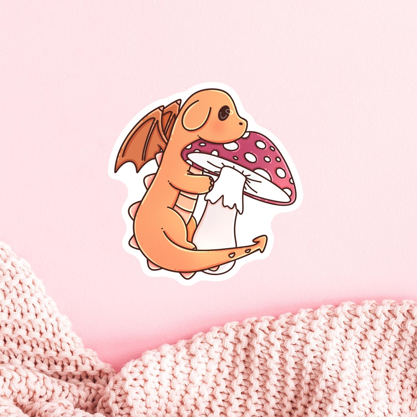 Orange Dragon autumn sticker on a laptop, cute fantasy die-cut sticker for book lovers who enjoy cozy reading season