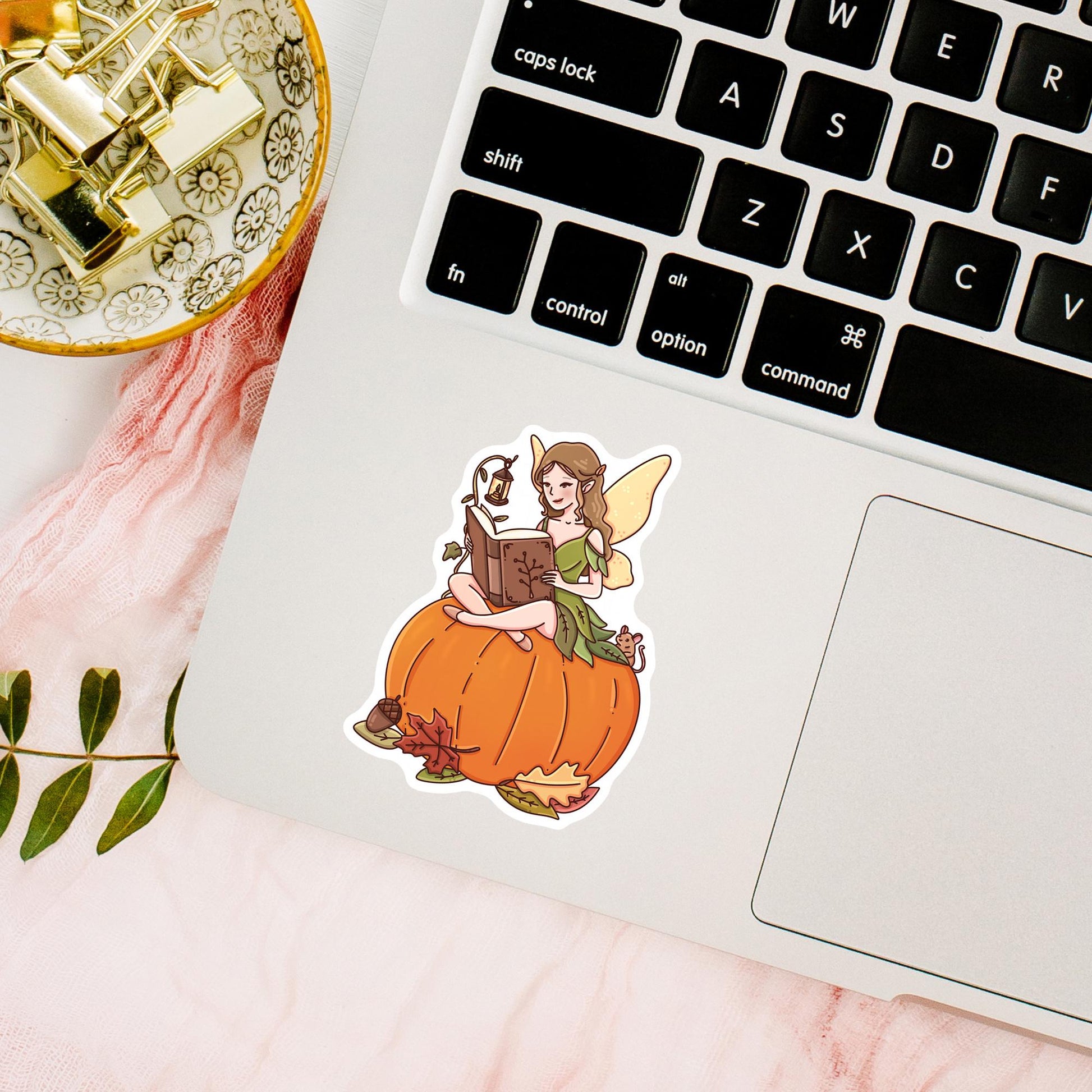 Autumn Fairy Tale bookish sticker on a cozy reading desk surrounded by fall leaves and candles