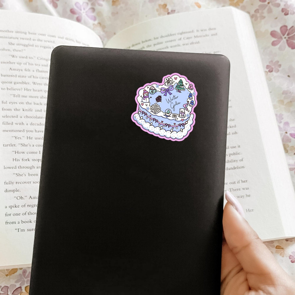 Winter Girlie Cake sticker on a black notebook cover, matte vinyl cozy winter decal, cute gift idea for journaling and desk decor
