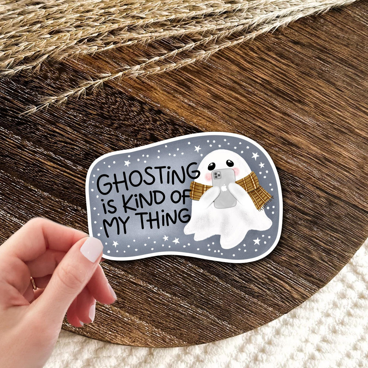 Ghosting Is Kind Of My Thing waterproof vinyl die-cut sticker held in hand over a wooden surface, funny sarcastic laptop and water bottle decal gift