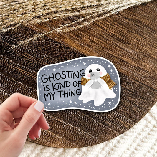 Ghosting Is Kind Of My Thing waterproof vinyl die-cut sticker held in hand over a wooden surface, funny sarcastic laptop and water bottle decal gift
