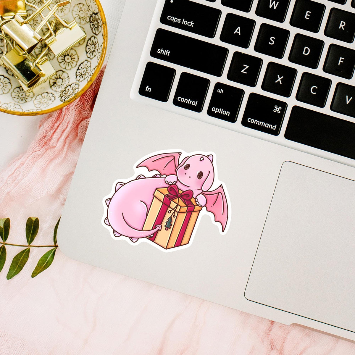 Cute Gift Box Dragon waterproof sticker on a laptop keyboard, pink fantasy dragon vinyl decal for laptops and tech decor